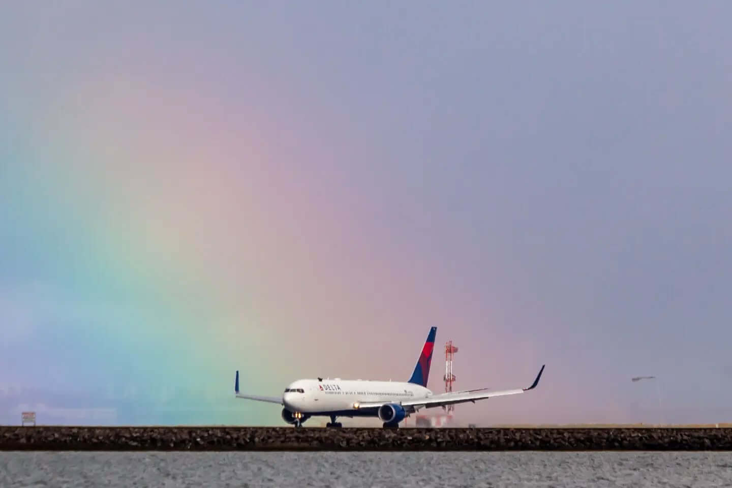 A rainbow at SFO while an Delta Air Lines Boeing 767-300(ER)  is landing on runway 19L. Thanks to the closure of runway 28L there is a new traffic pattern at SFO while taxiway construction is going on for the next 5 months.

@flysfo #rainbow #sfo #aviation #nature #planespotting #AviationPhotography 
@delta #Delta #deltaairl8nes #boeing #boeing767 #boeing767300er